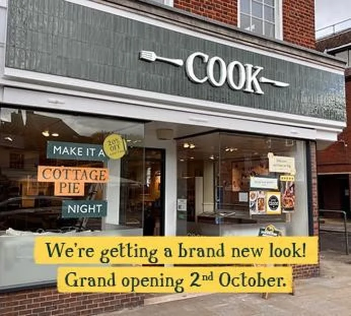 The COOK shopfront with its banner announcing a new look and a grand opening on 2 October